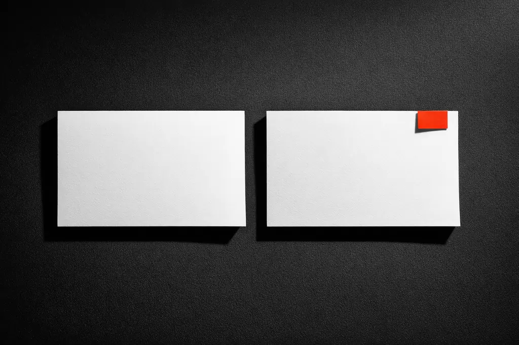 Two welcome bonus documents laid side by side on black surface, one flagged with a vermillion tab